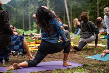Diverse people enjoy spiritual gathering A closeup view of a woman wearing denim leggings and shirt...