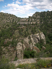 Fototapeta na wymiar Cliff Dwellings carved in rock on Walnut Canyon stone wall, Arizona