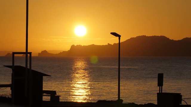 Sunrise orange sun with Porquerolles island in background mediterranean sea France