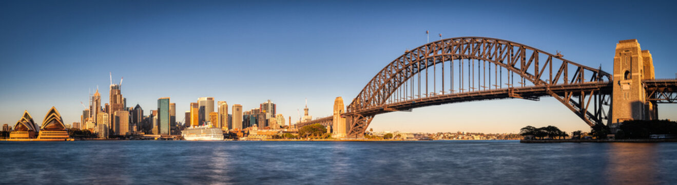 Sydney Harbour Panoramic with Harbour Bridge and Downtown Skyline. Cruise Ship and Blue Sky water.