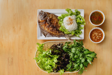 seafood background of thai style deep fried butterfish with sweet and sour sauce served with rice noodel and vegetable