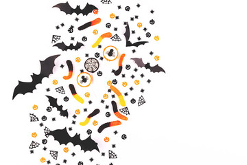 Halloween background made with candies, decoration and confetti.