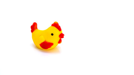 Close up of Little toy chicken sitting on isolated white background