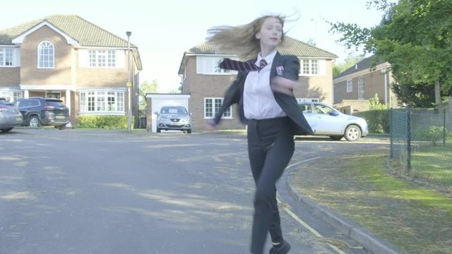 Senior school girl practising ballet on the way to school themes of ballet carefree routines education 