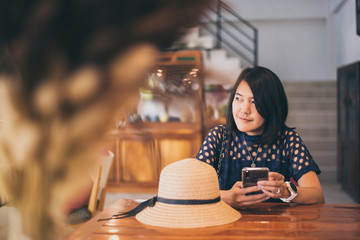 Beautiful asian woman sitting in cafe,Happy and smiling