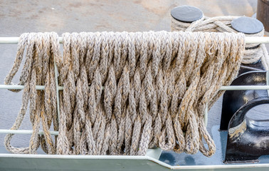Mooring rope is wound around a metal deck guard of a ship