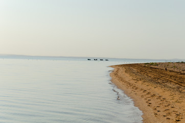 Boats with fishermen leaving for the sea early in the morning.