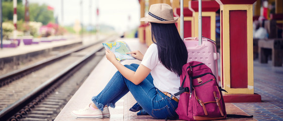  Young asian gril walking at train station before travel. work and travel concept.