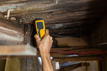 Indoor damp & air quality (IAQ) testing. An environmental home inspector is viewed close-up at...