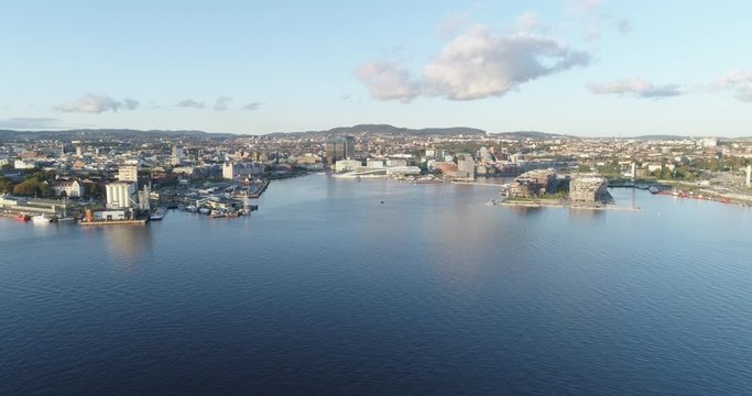 Cinema 4K drone shot with forward reveal motion of the new Bj&oslash;rvika quarter, with the Lambda Munch Museum, Oslo Opera House and S&oslash;renga in clear daylight in autumn fall, in Oslo Norway.