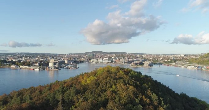 Cinema 4K drone shot with parallax motion of Hoved&oslash;ya island, the blue Oslofjord and the Bj&oslash;rvika project with the Lambda Munch Museum and Opera House in autumn fall, in Oslo Norway.
