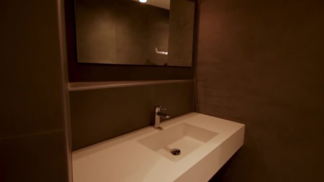 Medium wide shot of a huge modern basin. Camera pans aup.
