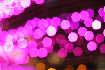 Blurred image of decorative bulbs light during festival such as Christmas and New Year. Beautiful bokeh for wallpaper of background. Defocus and out of focus.