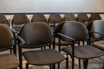Pregnant woman's echography appointment. A close up view on chairs inside an empty hospital waiting room, small comfortable armchairs in family planning clinic with copy space.