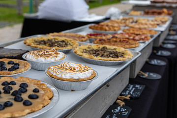 Baked goods at outdoor agriculture fair. Homemade traditional tarts are seen displayed on a stall...