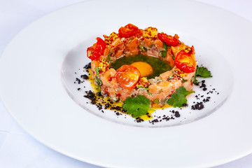 Salmon tartare with pesto and quail egg