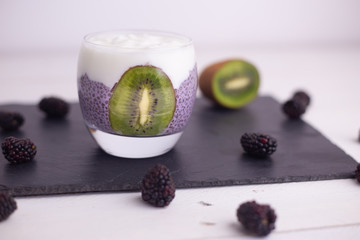 black chia pudding with blackberry and kiwi
