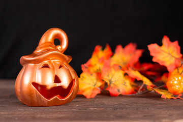 Halloween holiday. Halloween greeting card. Pumpkin with a happy face. Holiday decorations. Place for your text.