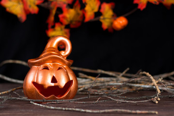 Halloween holiday. Halloween greeting card. Pumpkin with a happy face. Holiday decorations. Place for your text.