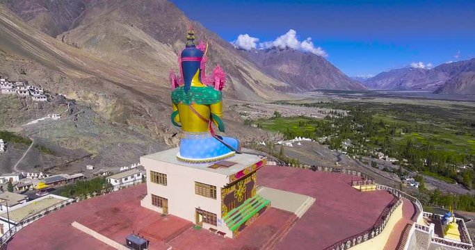 orbiting around the buddha statue in Diskit monastery in Nubra valley.//Drone shot