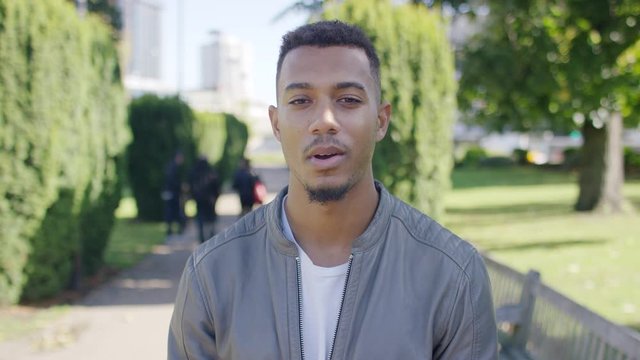 Attractive young male talking to camera in an interview style