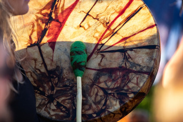Sacred drums during spiritual singing. A close up view of a traditionally dyed colorful native drum...