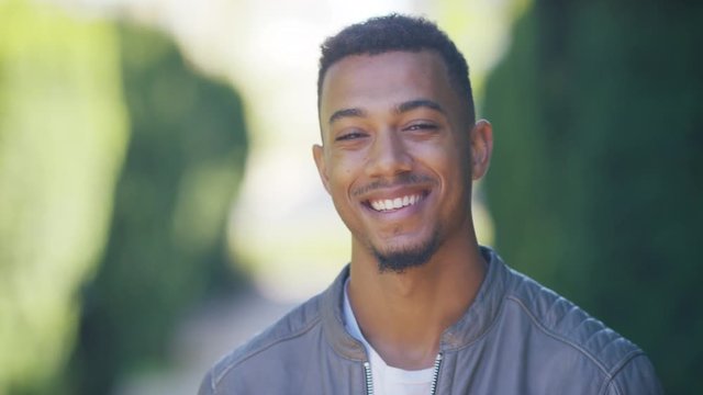 Portrait of handsome young man looking to camera and smiling