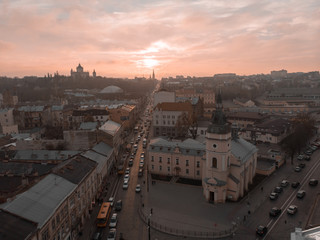 Fototapeta na wymiar Lviv, Ukraine - November 11, 2018: aerial view of sunset above old european city car traffic