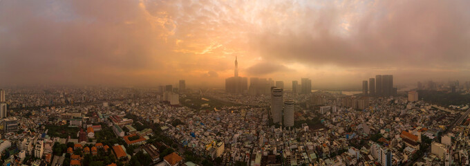 Beautiful aerial urban sunrise in Southeast Asia due to an extreme air pollution level. Ho Chi Minh...