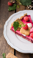 Raspberry tart with meringue on a wooden background