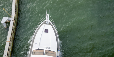 Top view of motorboat in green water.
