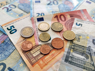 Euro money banknotes and coins background. 