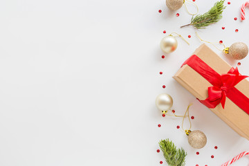 Christmas composition. Wrapped gift, wooden toys lying on white background. new year concept. Greeting card, winter holidays, xmas celebration 2020. Flat lay, top view, copy space, mockup, template