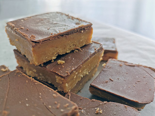 Millionaire's shortbread with chocolate and caramel. Copy space is on the right side.
