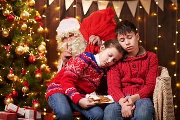 The children waited a long time for Santa, now they fell asleep and Santa quietly goes to the Christmas tree to give presents - Merry Christmas and Happy Holidays!