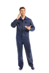 Male car mechanic talking by phone on white background