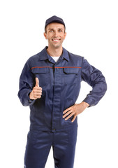 Fototapeta premium Male car mechanic showing thumb-up on white background