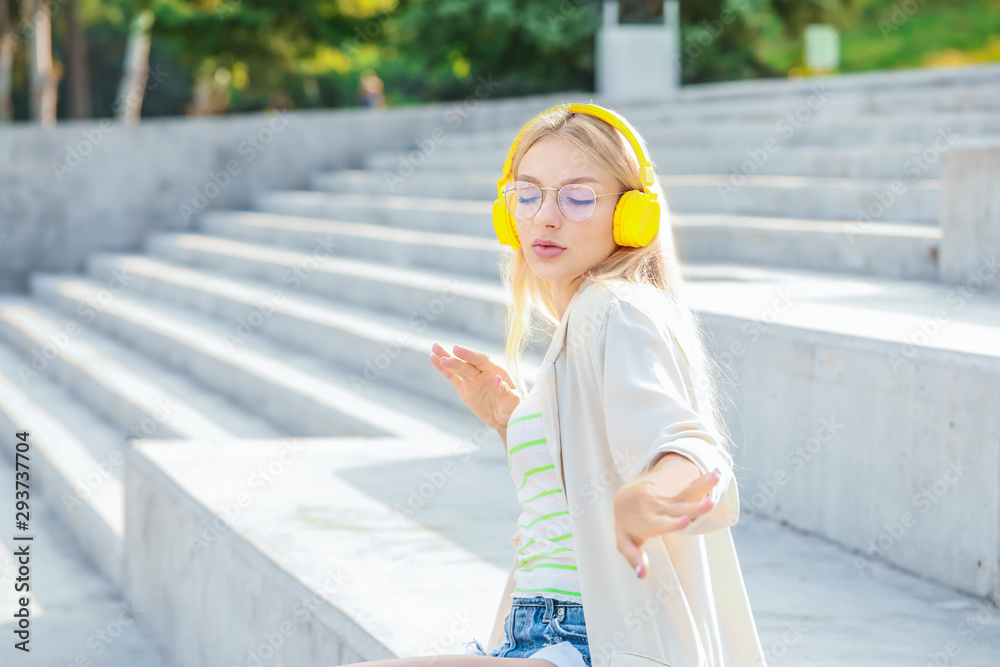 Sticker Beautiful young woman listening to music outdoors