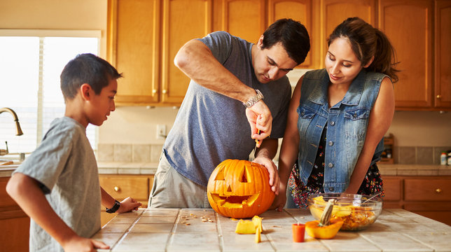 Halloween Activity - Family Carving Pumpkin Into Jack-o-lantern
