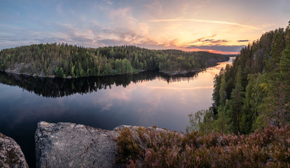 Scenic forest landscape with tarnquil mood and idyllic sunset at summer evening in Finland