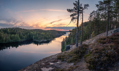 Scenic forest landscape with tarnquil mood and idyllic sunset at summer evening in Finland