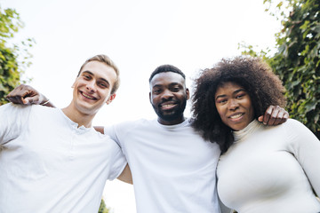 Intercultural friends looking at camera