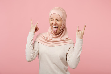 Arabian muslim woman in hijab light clothes posing isolated on pink background. People religious...