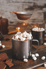 Cup of hot chocolate with marshmallows on table