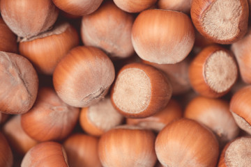 Unpeeled hazelnuts closeup top view. Autumn season harvesting. Market place.