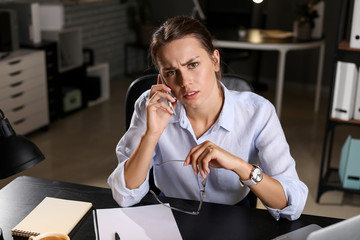 Tired businesswoman trying to meet deadline in office