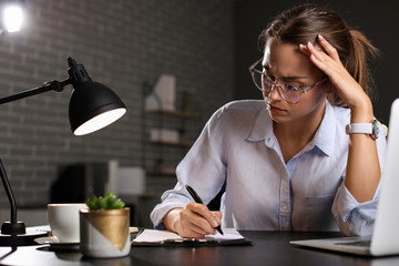 Tired businesswoman trying to meet deadline in office