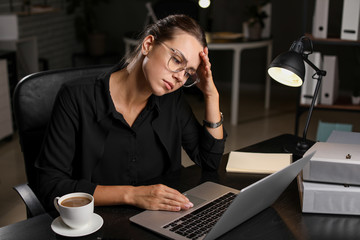 Tired businesswoman trying to meet deadline in office