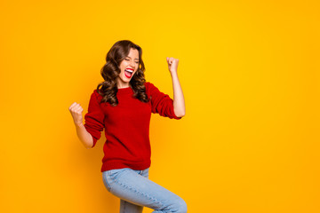 Photo of trendy cheerful charming nice fascinating girlfriend wearing jeans denim making fists rejoicing with victory isolated over vivid color background