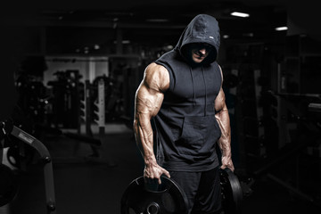 Muscular athletic bodybuilder fitness model posing after exercises in gym - Powered by Adobe